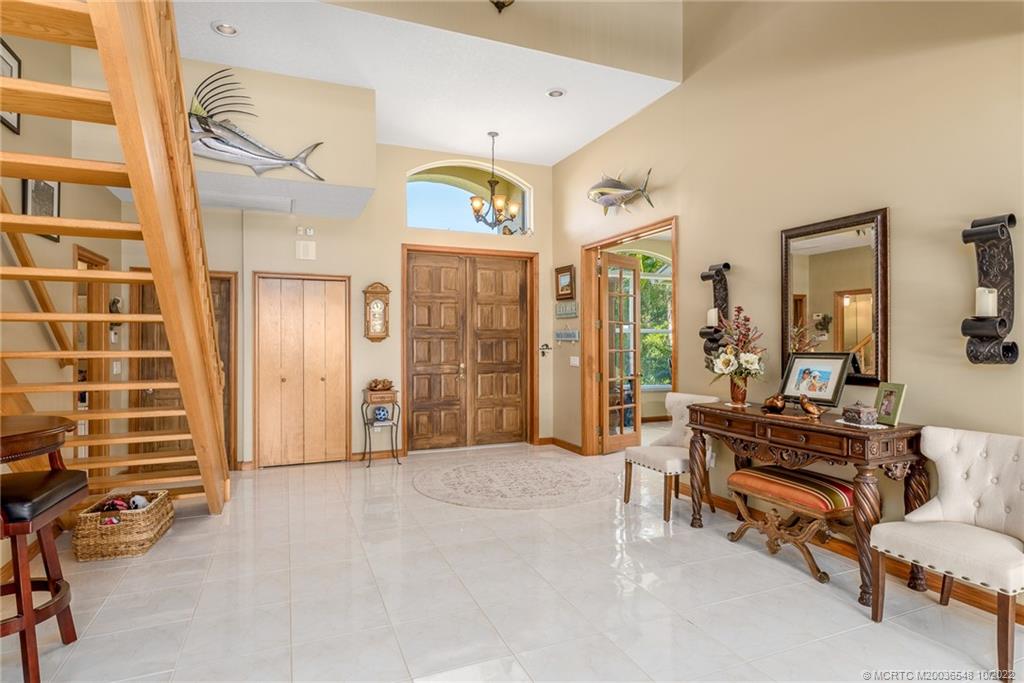 5854 Southeast Horseshoe Point Road Stuart, FL 34997 - Photo 31 of 56 a living room with furniture and a flat screen tv