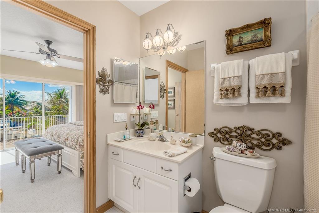 5854 Southeast Horseshoe Point Road Stuart, FL 34997 - Photo 38 of 56 a bathroom with a sink a toilet and a mirror