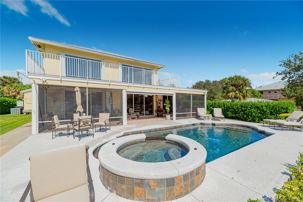 5854 Southeast Horseshoe Point Road Stuart, FL 34997 - Photo 40 of 56 a view of house with swimming pool and outdoor seating