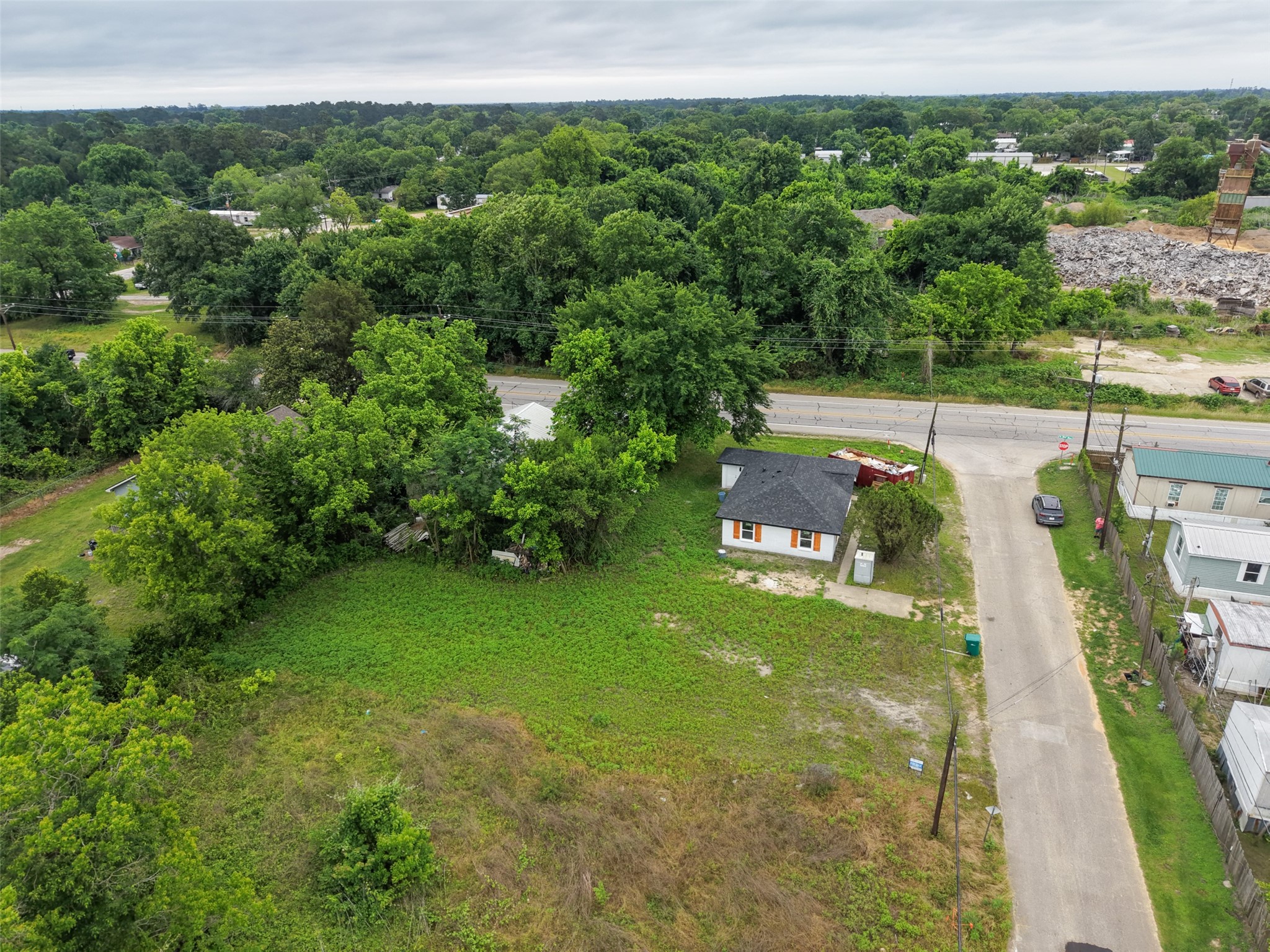 0 Mill Street Willis, TX 77378 - Photo 7 of 24 a view of a garden with a building in the background