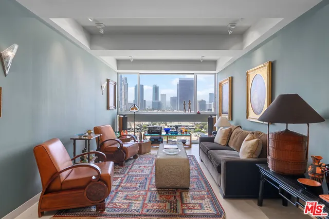 a living room with furniture a lamp and a window