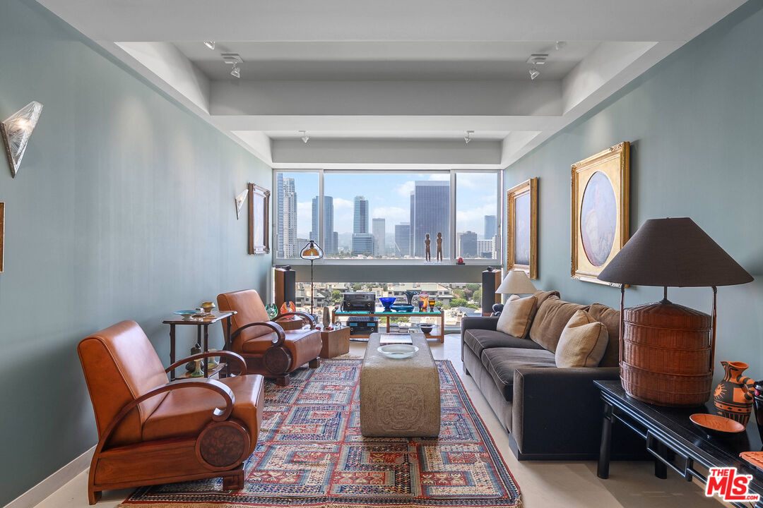 2222 Avenue Of The Stars, Unit 1404 Los Angeles, CA 90067 - Photo 4 of 12 a living room with furniture a lamp and a window