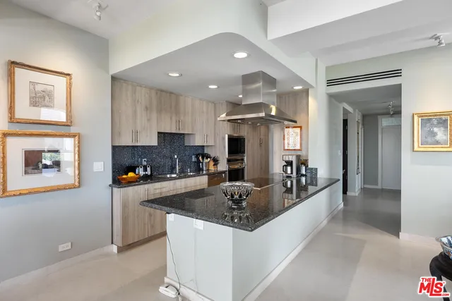 a kitchen with stainless steel appliances granite countertop a sink and a refrigerator