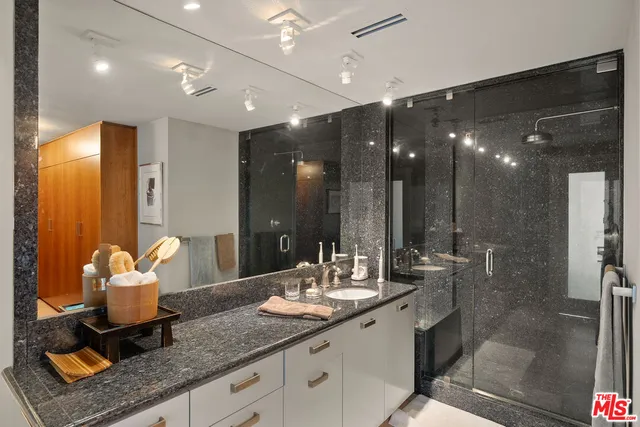 a bathroom with sinks mirror and shower
