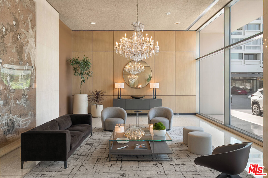 2222 Avenue Of The Stars, Unit 1404 Los Angeles, CA 90067 - Photo 10 of 12 a living room with furniture a chandelier and a large mirror