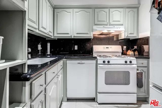 a kitchen with stainless steel appliances granite countertop a stove and a refrigerator