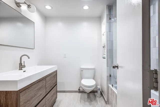 a bathroom with a toilet a sink and a mirror