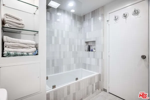 a bathroom with a bathtub and a shower