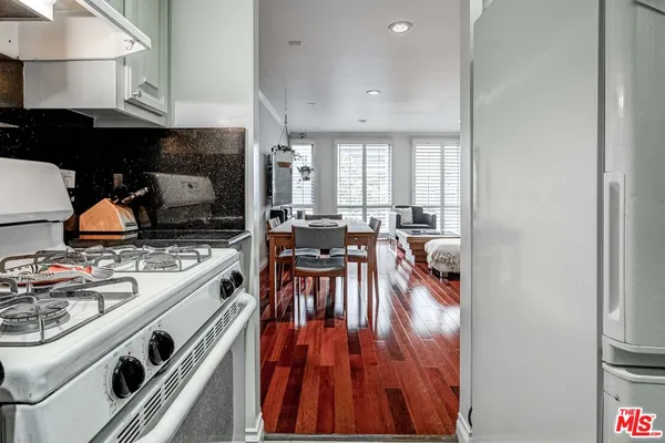 a view of a kitchen with stove and cabinets