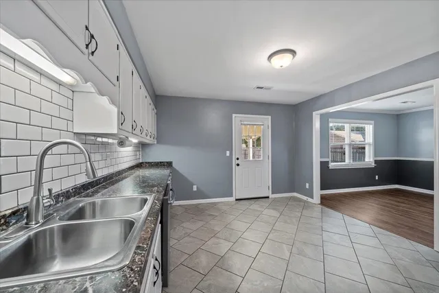 a kitchen with a sink cabinets and appliances