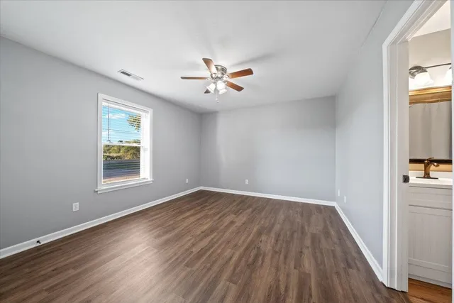 wooden floor in an empty room with a window