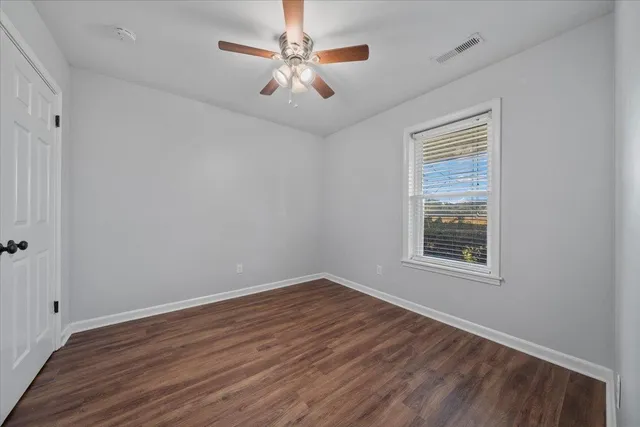 wooden floor in an empty room with a window