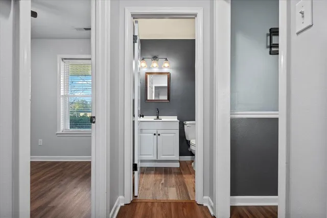 a bathroom with a sink a toilet and a mirror