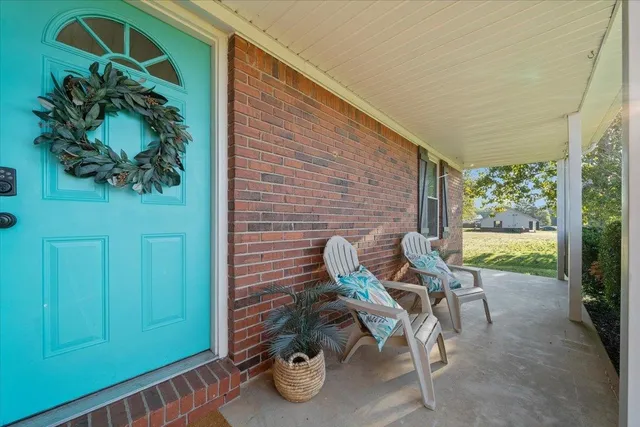 a view of a porch with chairs and a potted plant