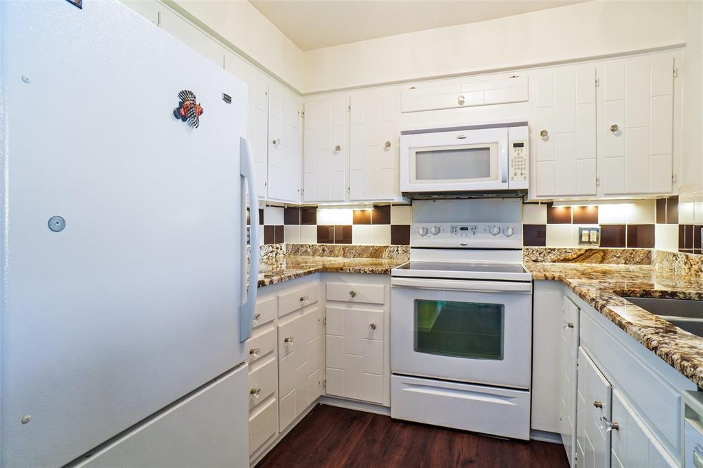 388 Driftwood Court, Unit 1A Azle, TX 76020 - Photo 11 of 29 Plenty of cabinets, food pantry in hall just arms reach away