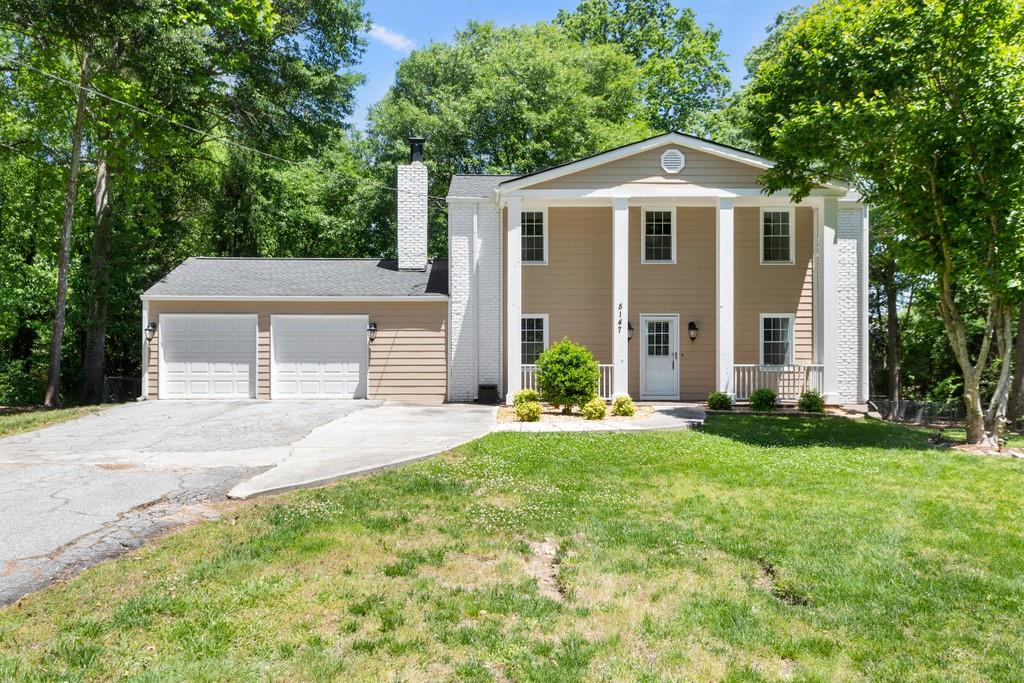 5147 Winters Chapel Road Atlanta, GA 30360 - Photo 1 of 1 a front view of a house with a yard and trees