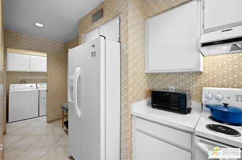 a kitchen with a refrigerator and a stove