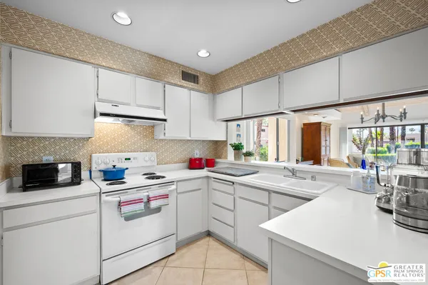 a kitchen that has a sink and a stove in it