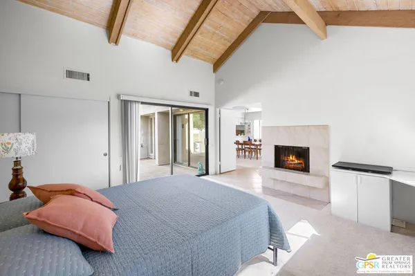 a bedroom with a bed and a fireplace