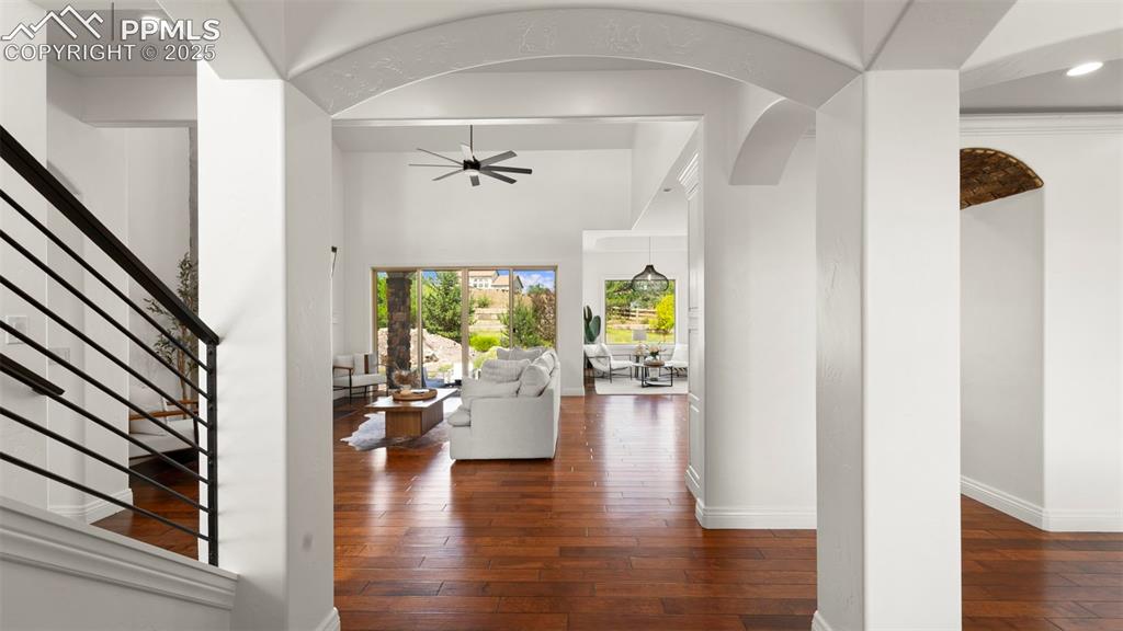 13625 Random Ridge View Colorado Springs, CO 80921 - Photo 5 of 50 Entryway featuring stairs, dark wood-style floors, arched walkways, a ceiling fan, and recessed lighting