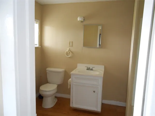 a white toilet sitting next to a bathroom sink