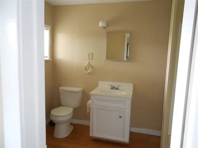a white toilet sitting next to a bathroom sink