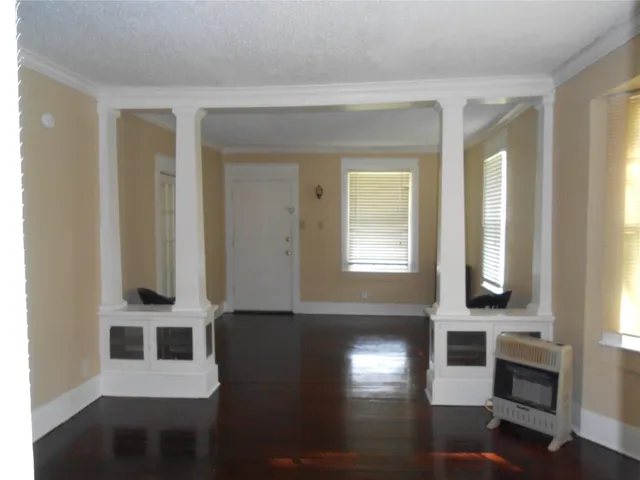 a view of a windows and an entryway with wooden floor