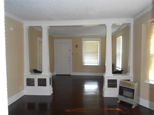 a view of a windows and an entryway with wooden floor