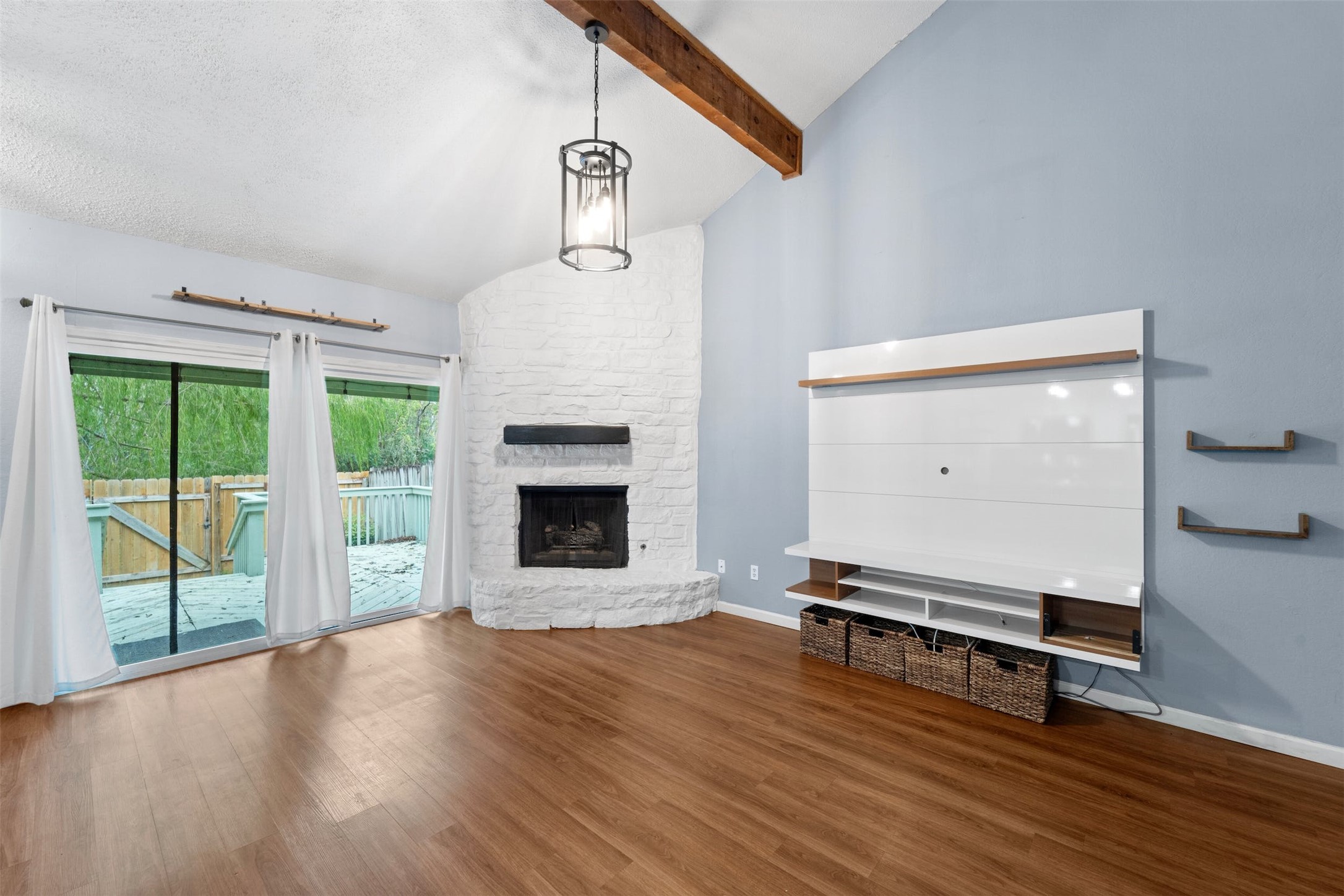 500 Hesters Crossing Road, Unit 209 Round Rock, TX 78681 - Photo 3 of 24 a view of empty room with wooden floor and fireplace