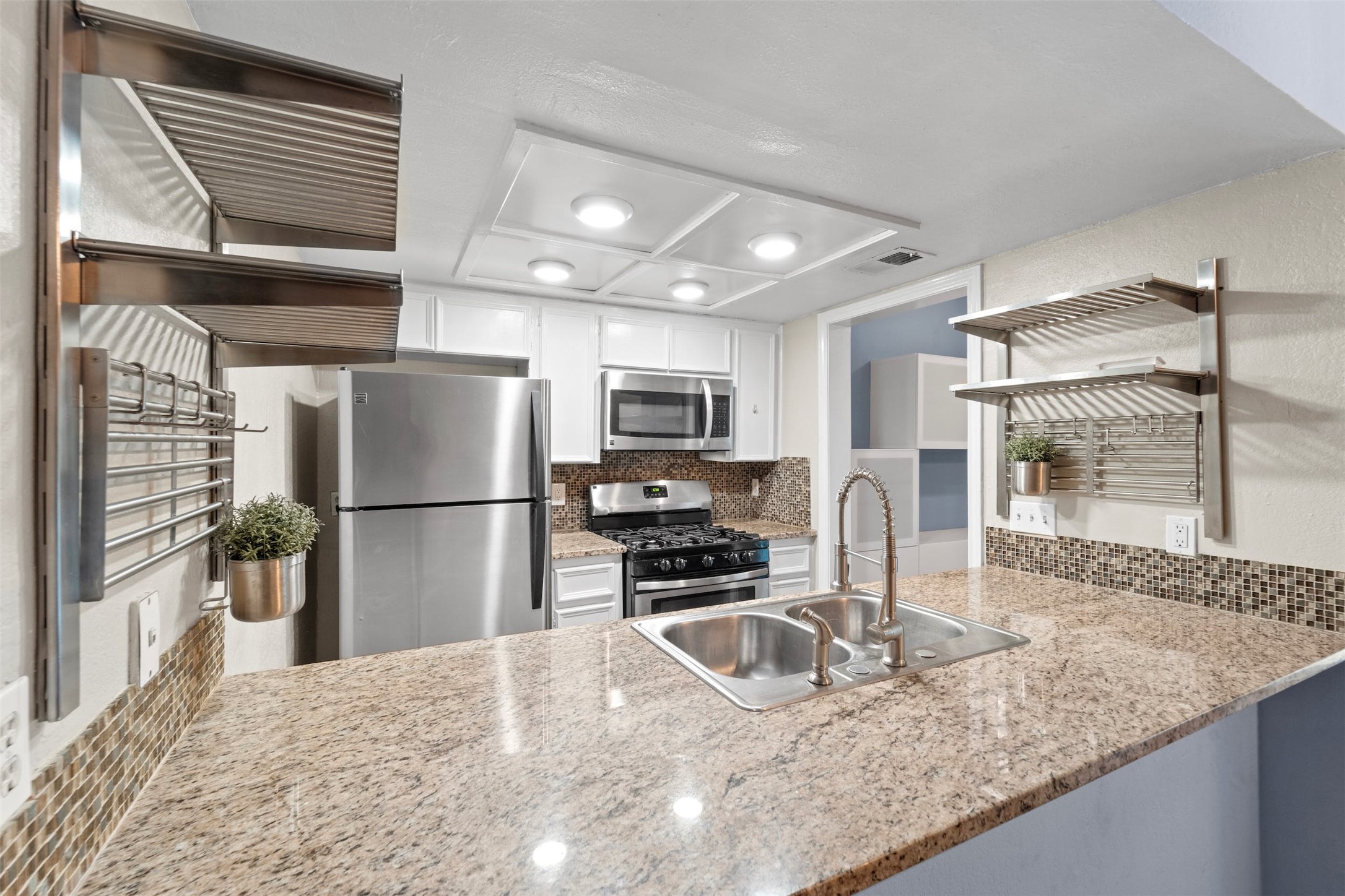 500 Hesters Crossing Road, Unit 209 Round Rock, TX 78681 - Photo 7 of 24 a kitchen with stainless steel appliances granite countertop a refrigerator a stove and a sink