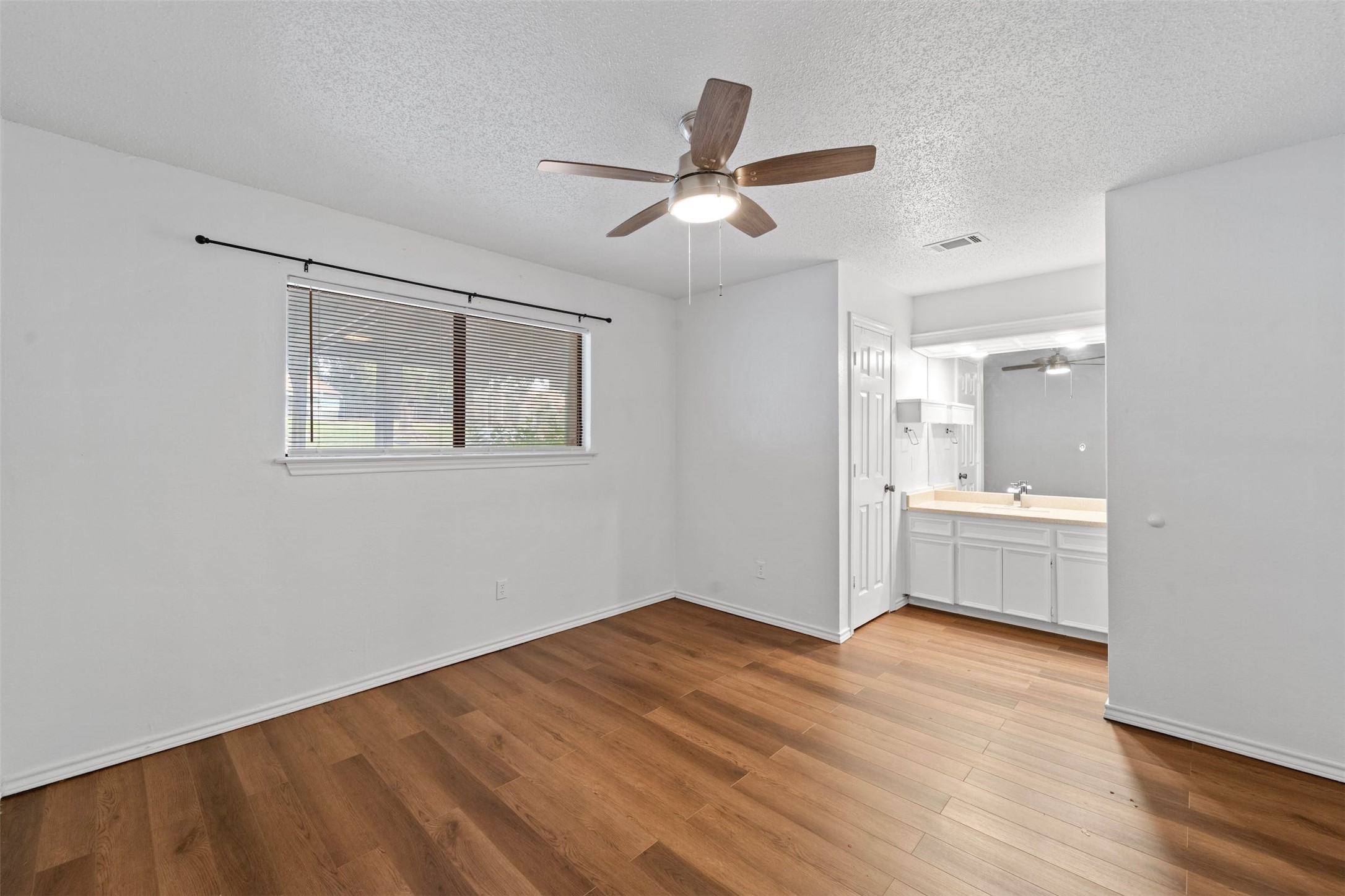 500 Hesters Crossing Road, Unit 209 Round Rock, TX 78681 - Photo 10 of 24 a view of empty room with wooden floor and window