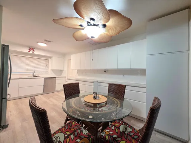 a bedroom with a bed and dresser with chair