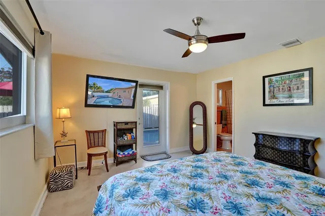 a view of a patio with a table and chairs under an umbrella