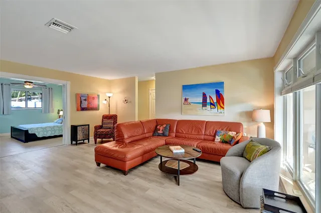 a living room with furniture and large window