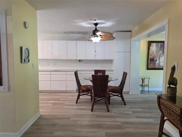 a view of a a dining room with furniture window and wooden floor