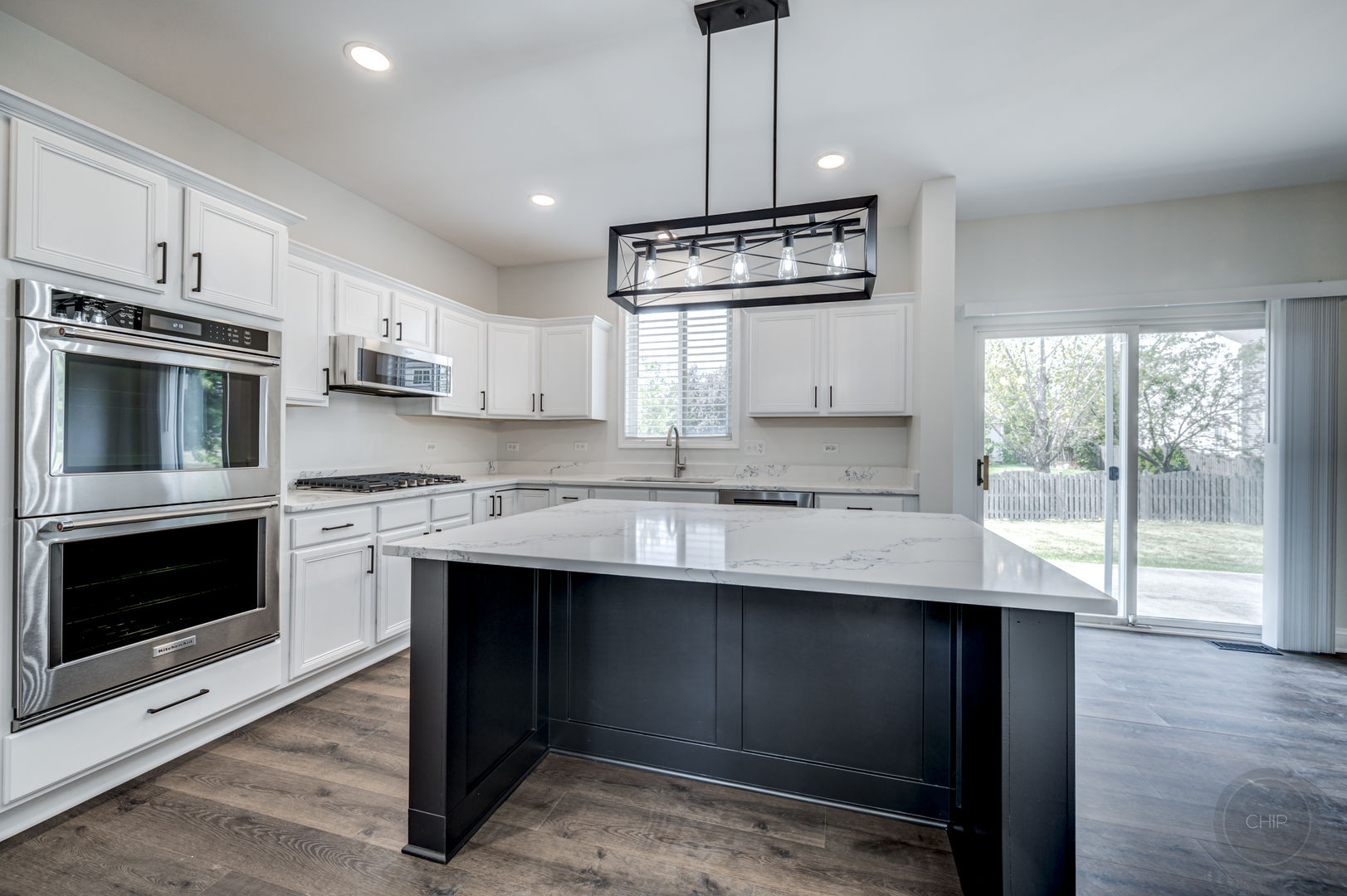 12948 Parterre Place Plainfield, IL 60585 - Photo 13 of 35 a kitchen with kitchen island granite countertop stainless steel appliances a stove sink and microwave