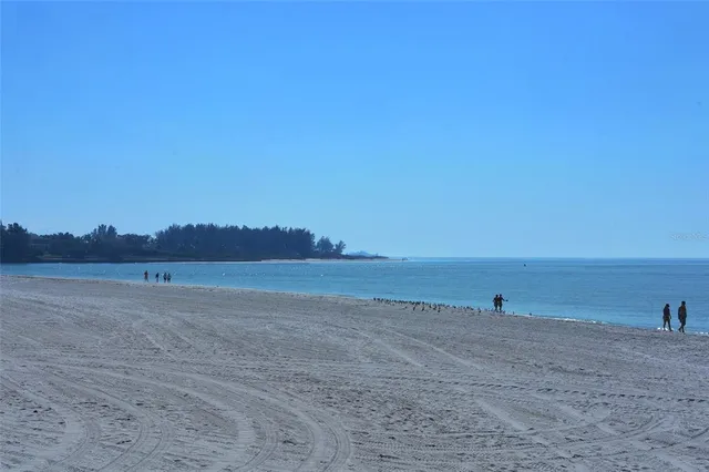 a table with white sheets and pillows on it