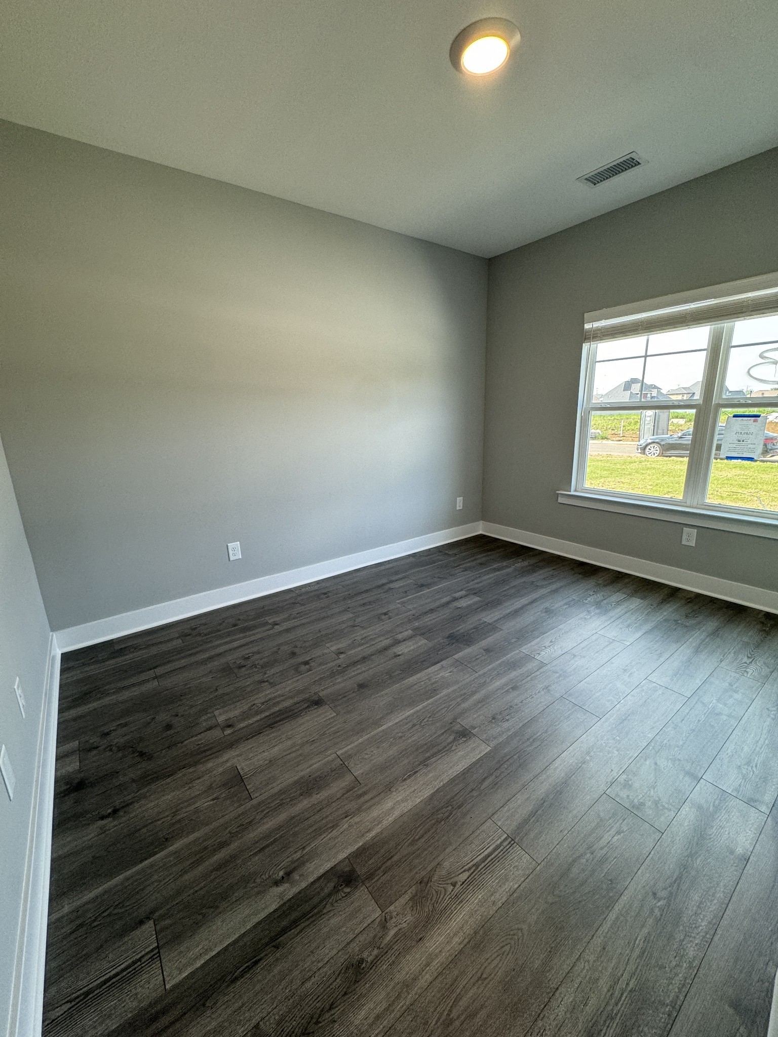 5482 Rooker Road Smyrna, TN 37167 - Photo 5 of 30 an empty room with wooden floor and windows