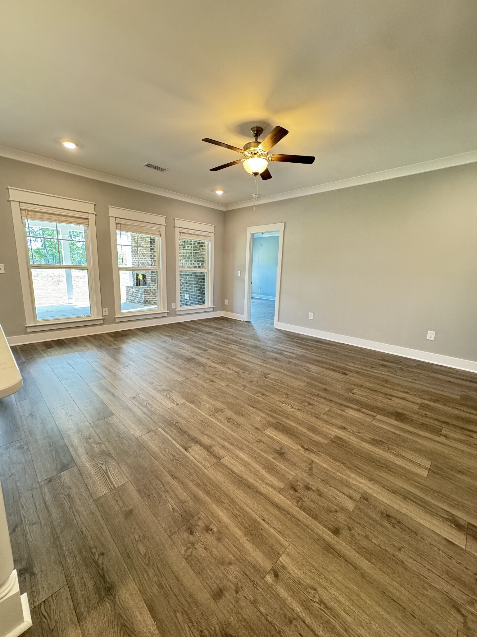 5482 Rooker Road Smyrna, TN 37167 - Photo 8 of 30 an empty room with wooden floor chandelier fan and windows