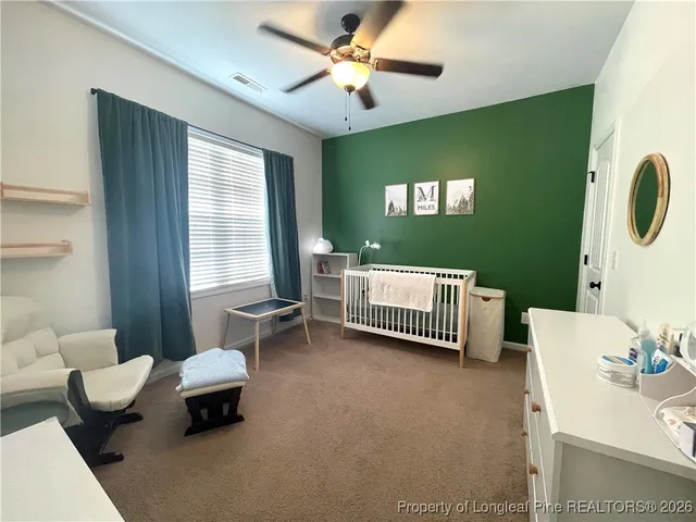 a bed room with a bed and a chair