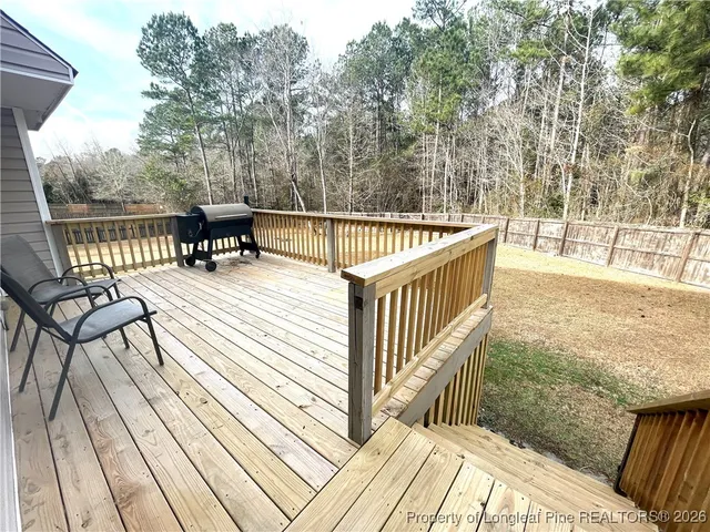a view of balcony with wooden floor and outdoor seating