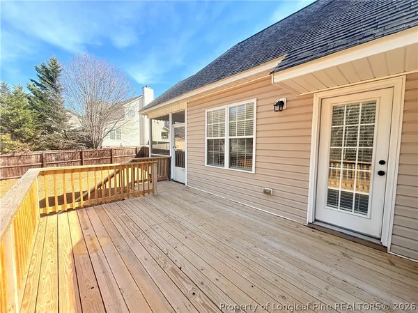 a view of a yard with wooden fence