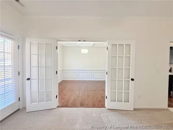 an empty room with cabinet and mirrors