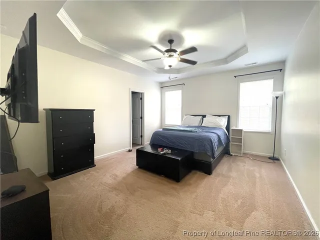 a spacious bedroom with a bed and a chandelier