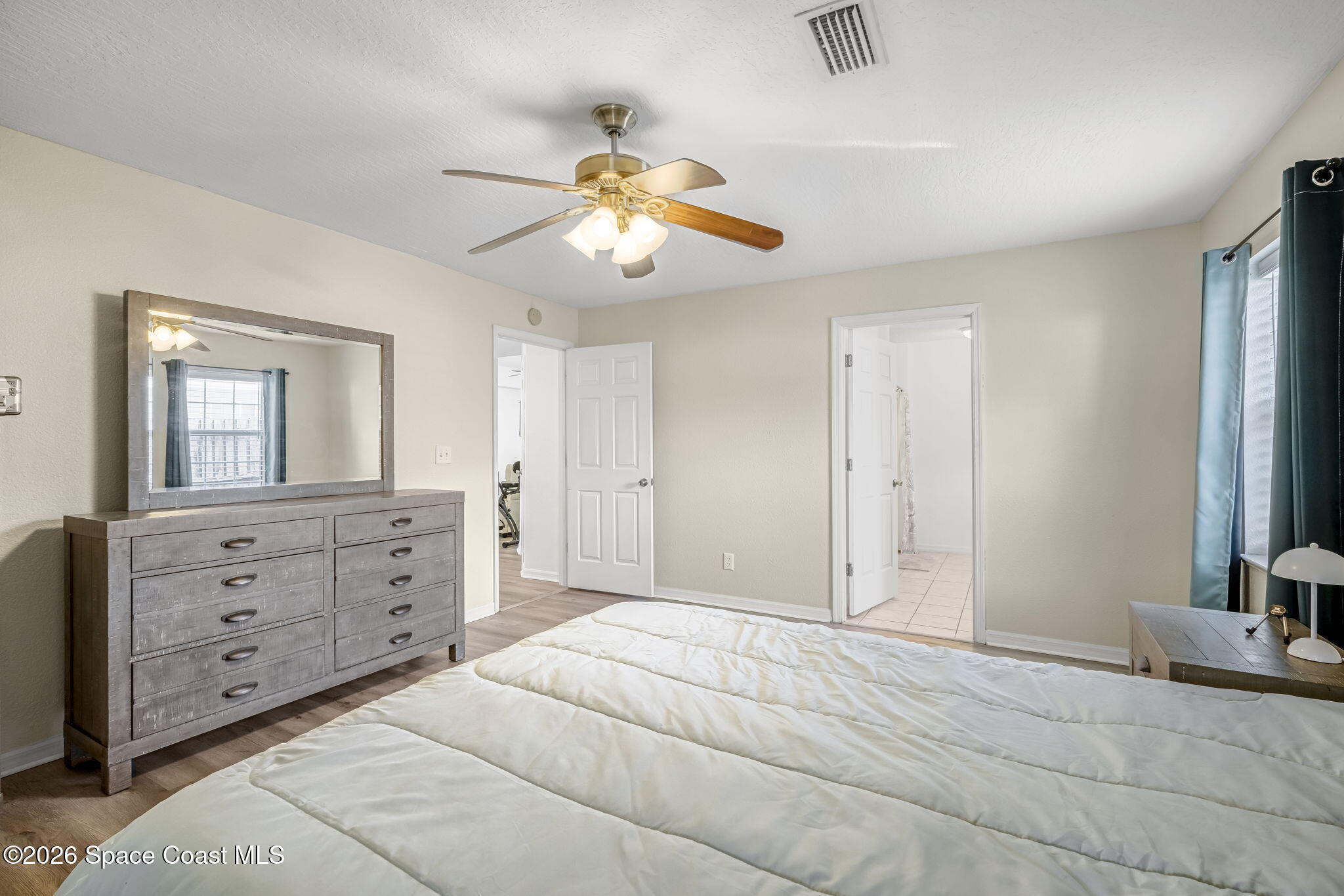 3404 Kilbee Street Mims, FL 32754 - Photo 16 of 30 a bedroom with a bed and a chandelier
