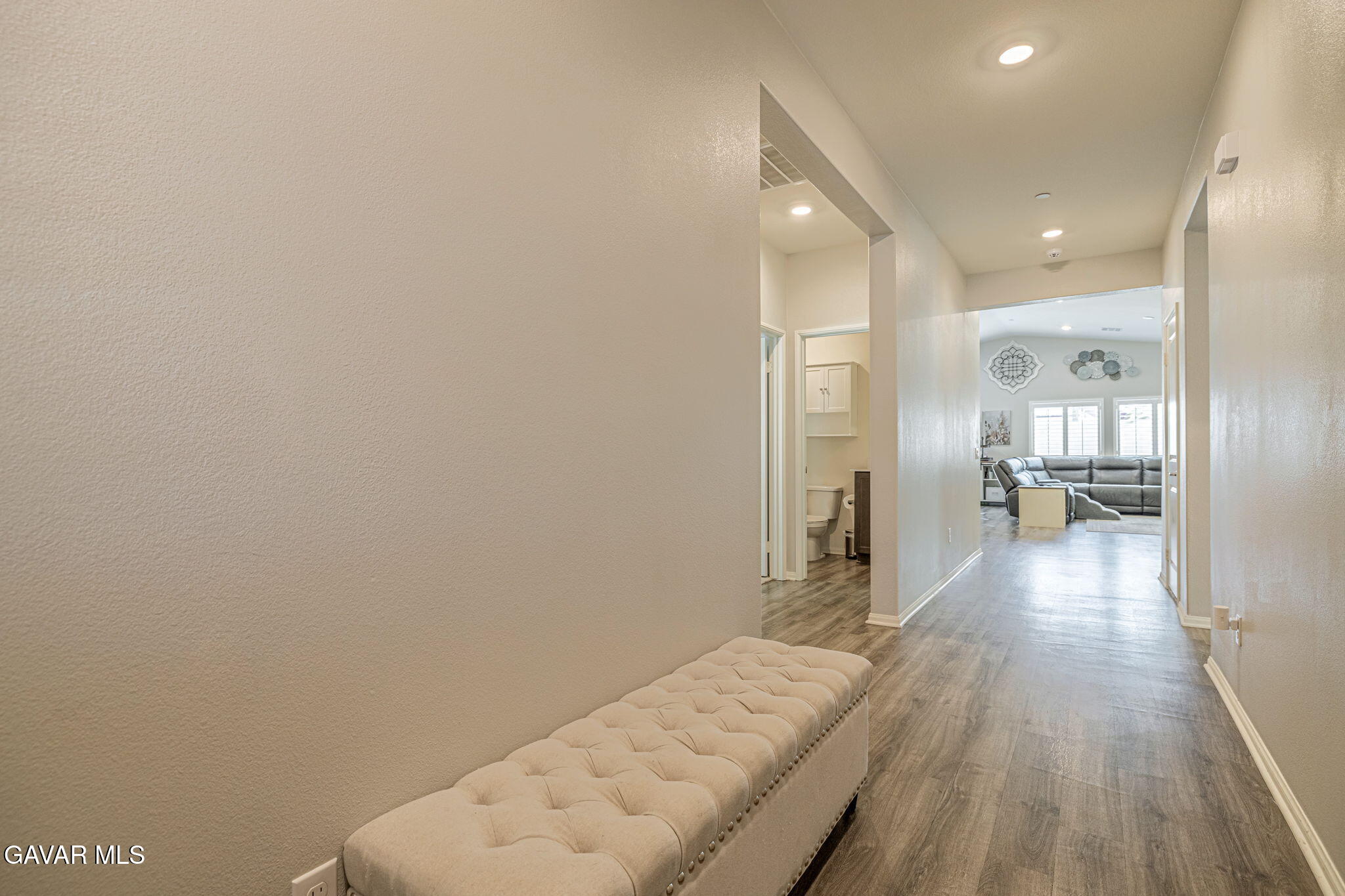 44302 Marbella Street Lancaster, CA 93536 - Photo 19 of 38 a view of a hallway with wooden floor windows and a kitchen