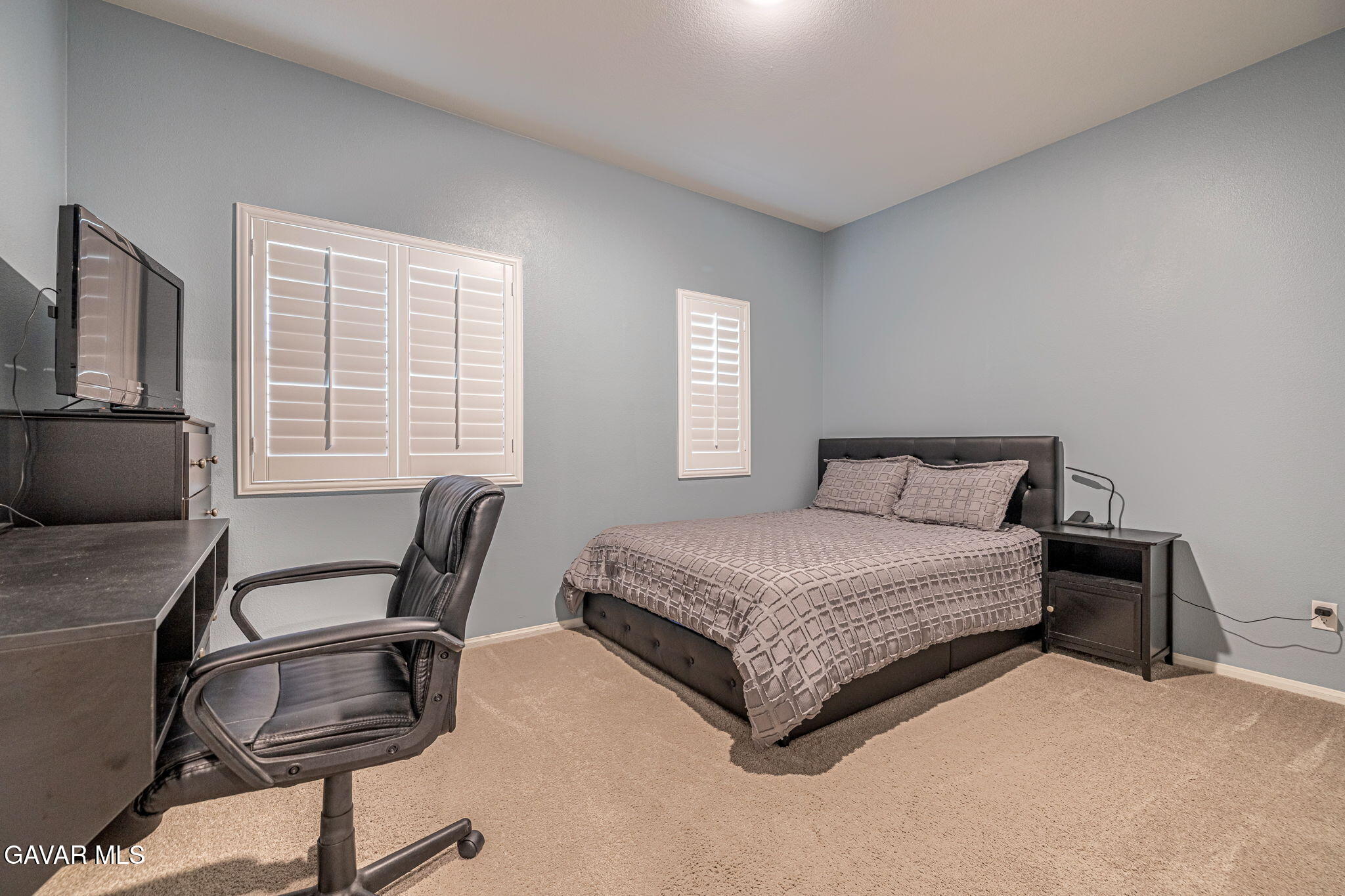 44302 Marbella Street Lancaster, CA 93536 - Photo 21 of 38 a bedroom with a bed windows and chair