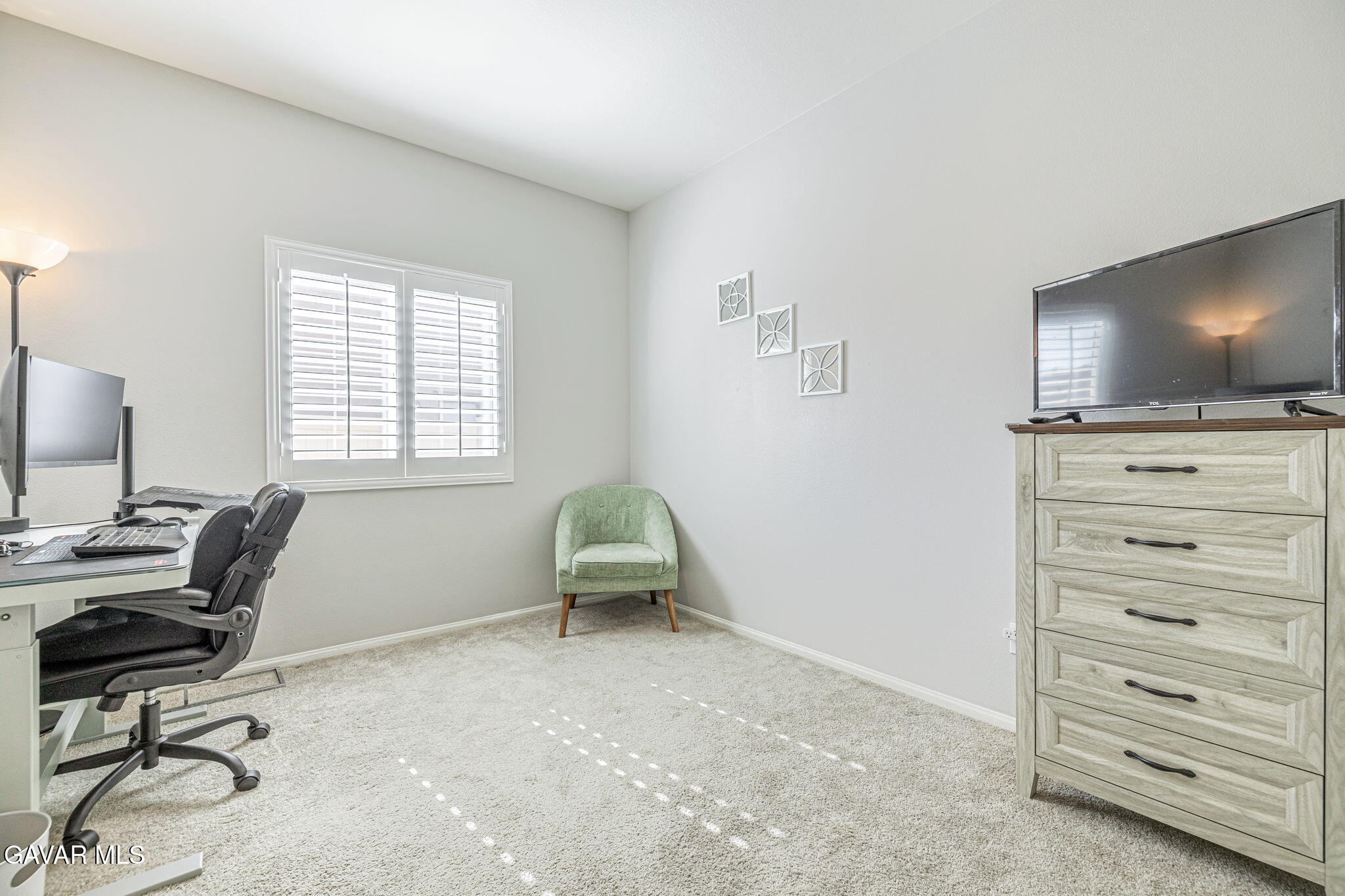 44302 Marbella Street Lancaster, CA 93536 - Photo 25 of 38 a livingroom with a flat screen tv and gym equipment