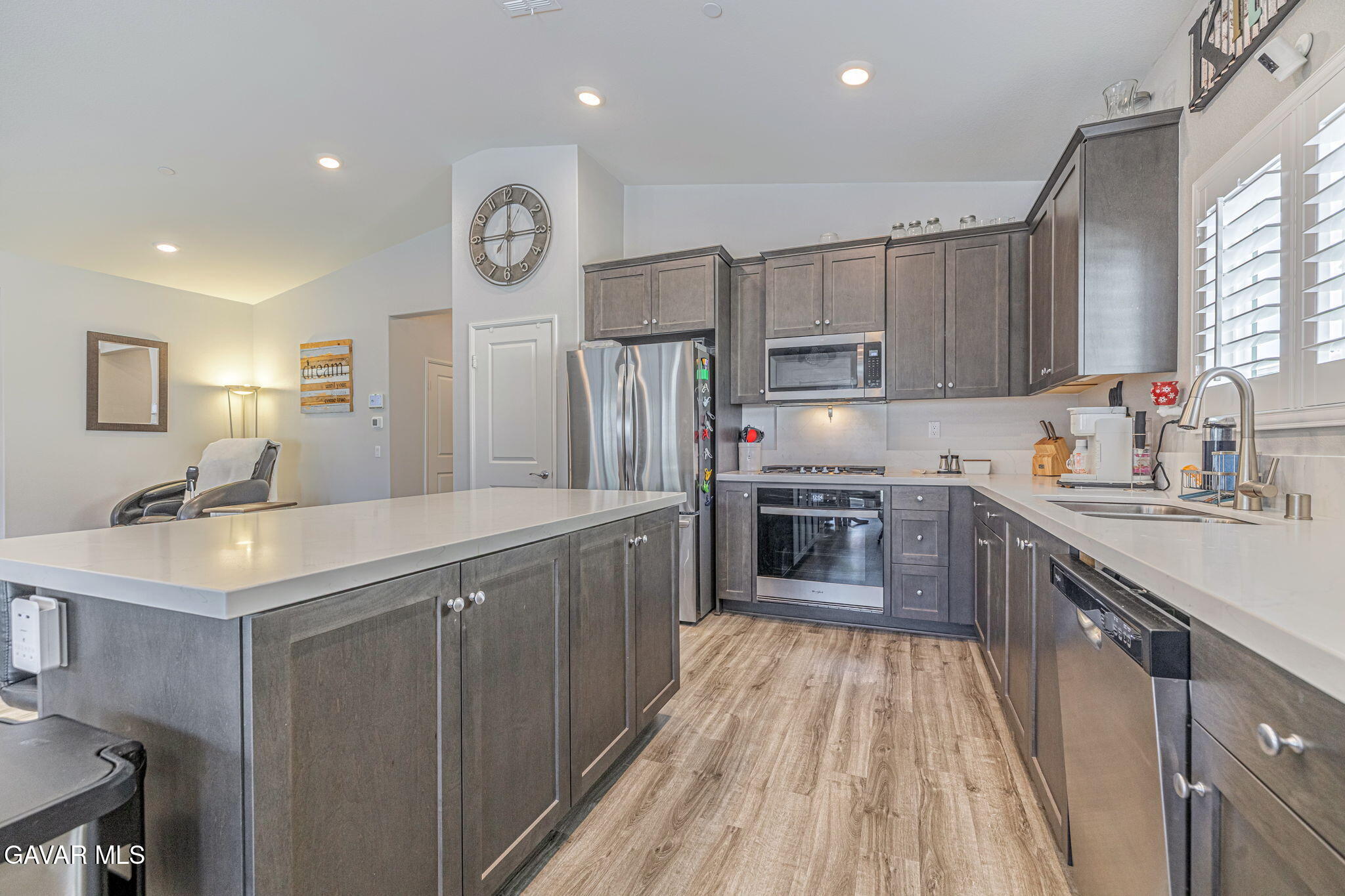 44302 Marbella Street Lancaster, CA 93536 - Photo 34 of 38 a kitchen with a sink counter top space stainless steel appliances and a window