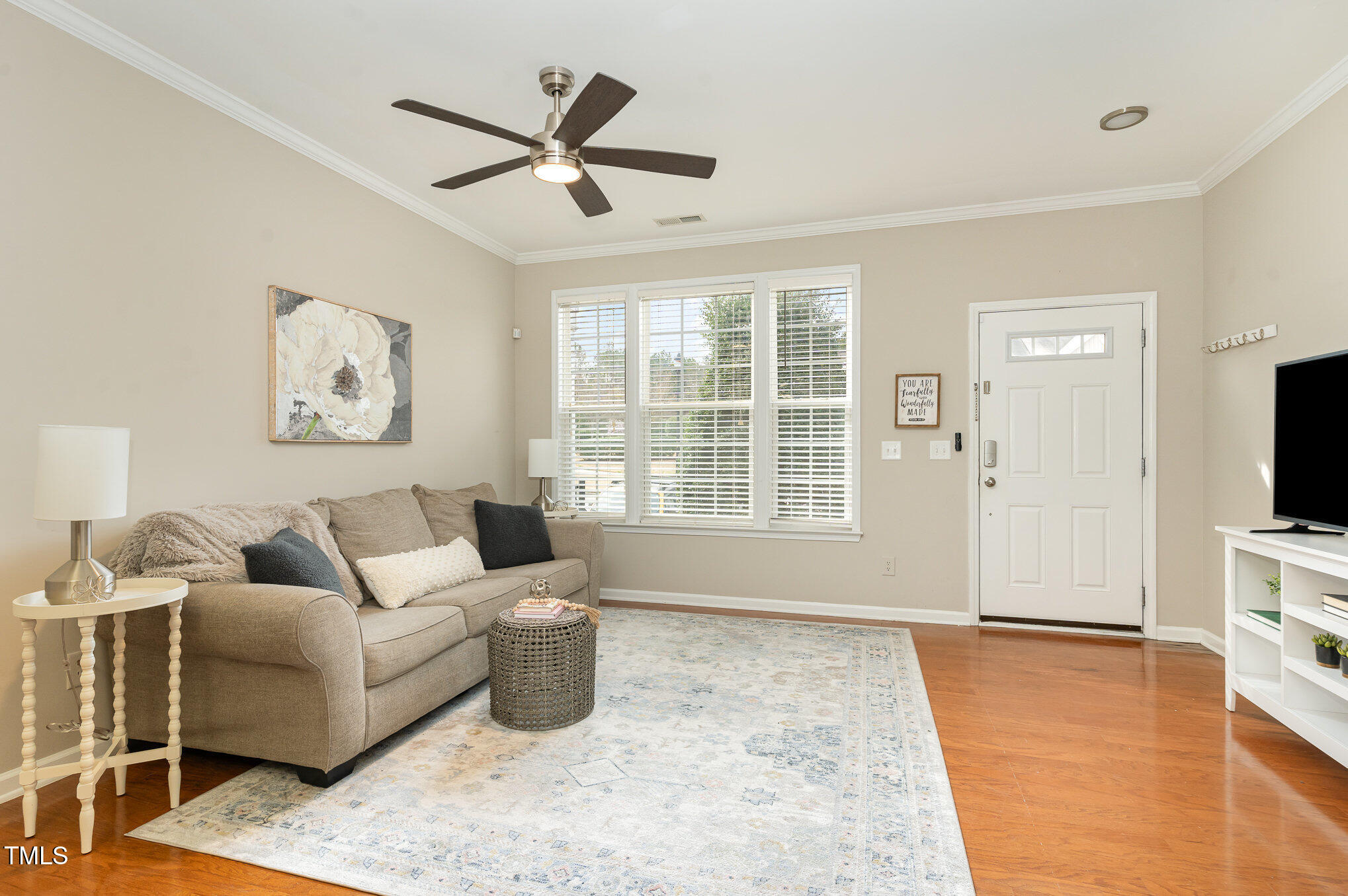 7810 Spungold Street Raleigh, NC 27617 - Photo 2 of 12 a living room with furniture and a flat screen tv